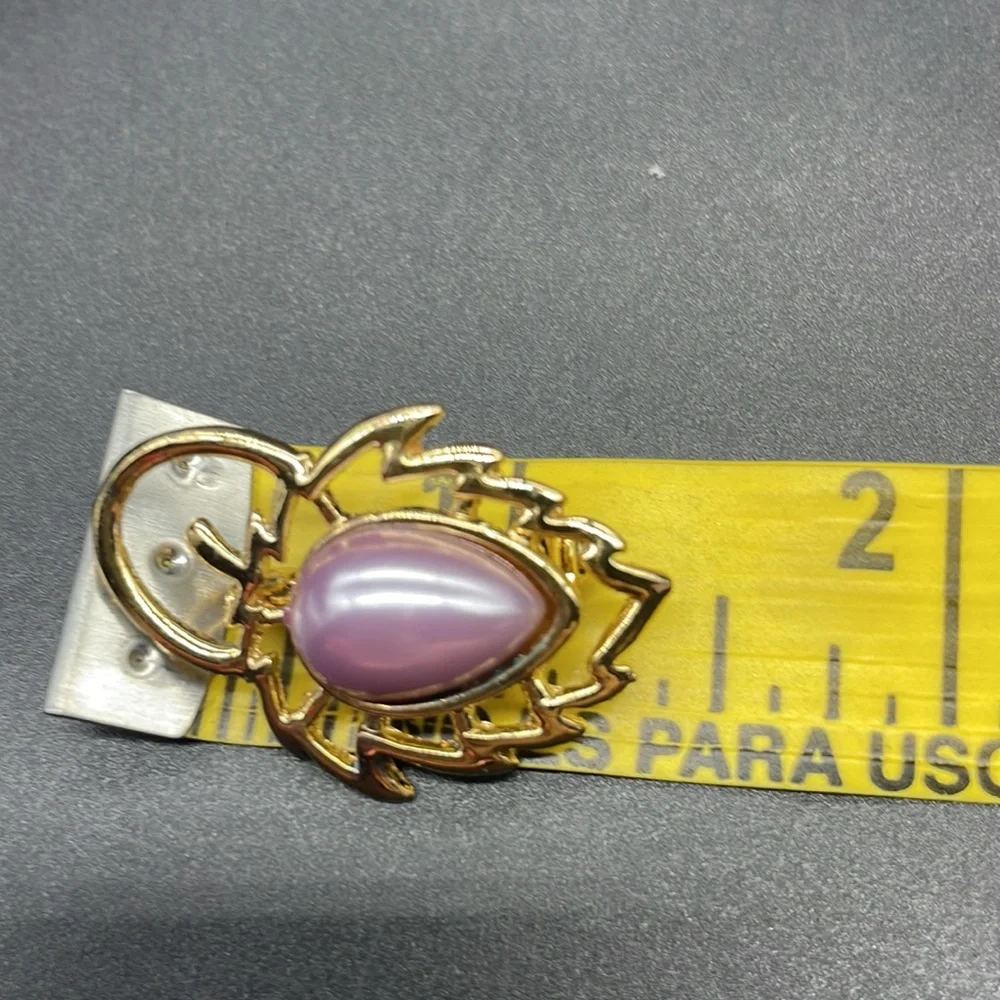 Gold plated brooch with a stone in the center | the stone color is a lavender